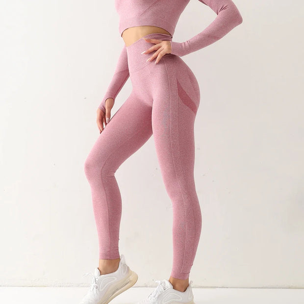 Woman wearing seamless leggings in pink, performing yoga